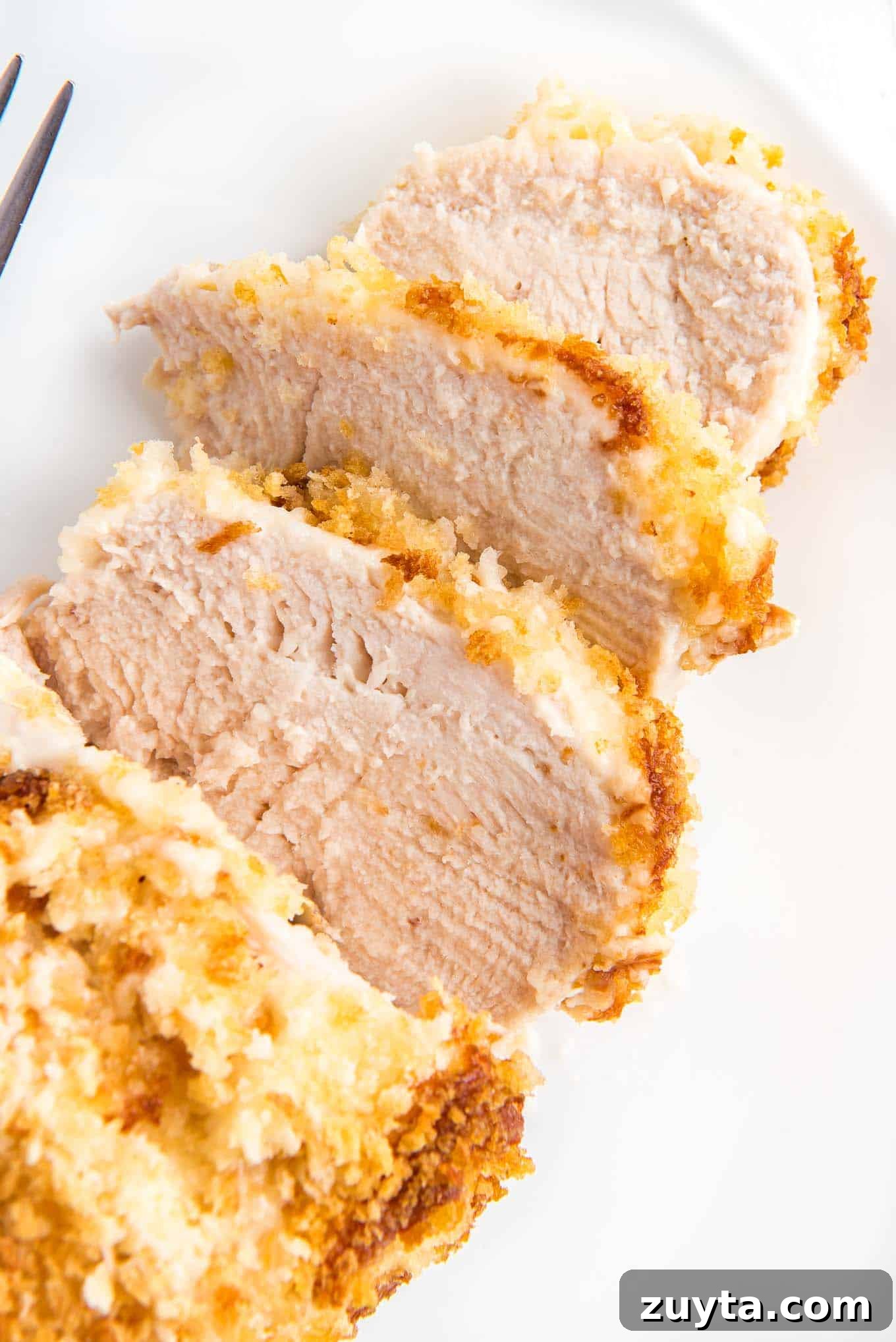 4-Ingredient Crispy Panko Chicken Recipe 10 Panko chicken served on a plate and cut into slices to show the inside.