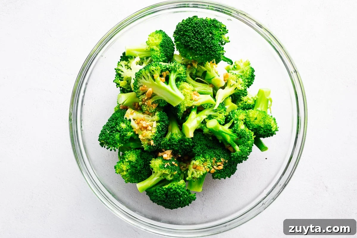 Sesame broccoli salad in a mixing bowl viewed from above.