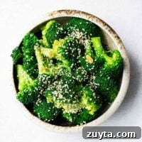 A bowl of Korean broccoli banchan sprinkled with toasted sesame seeds.