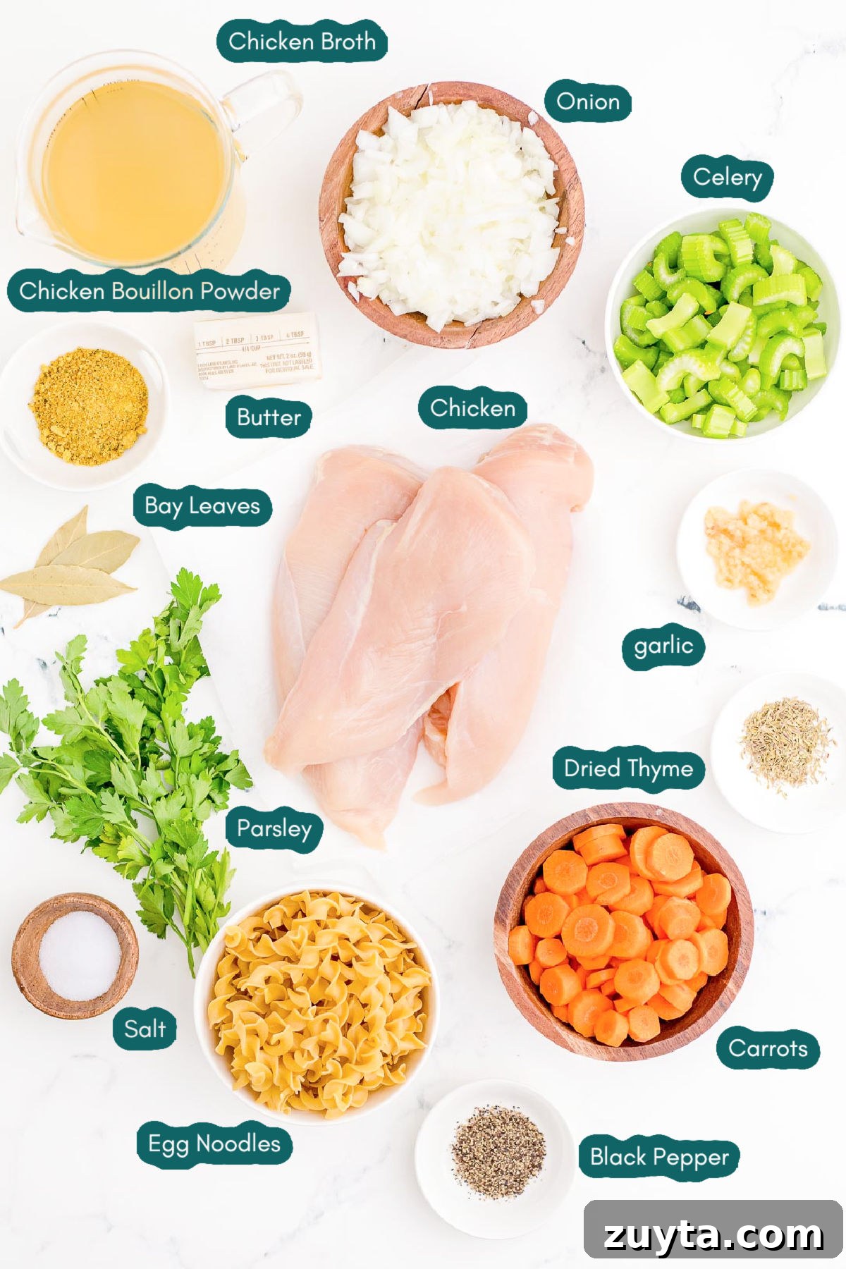 Ingredients to make instant pot chicken noodle soup from scratch on a white surface.