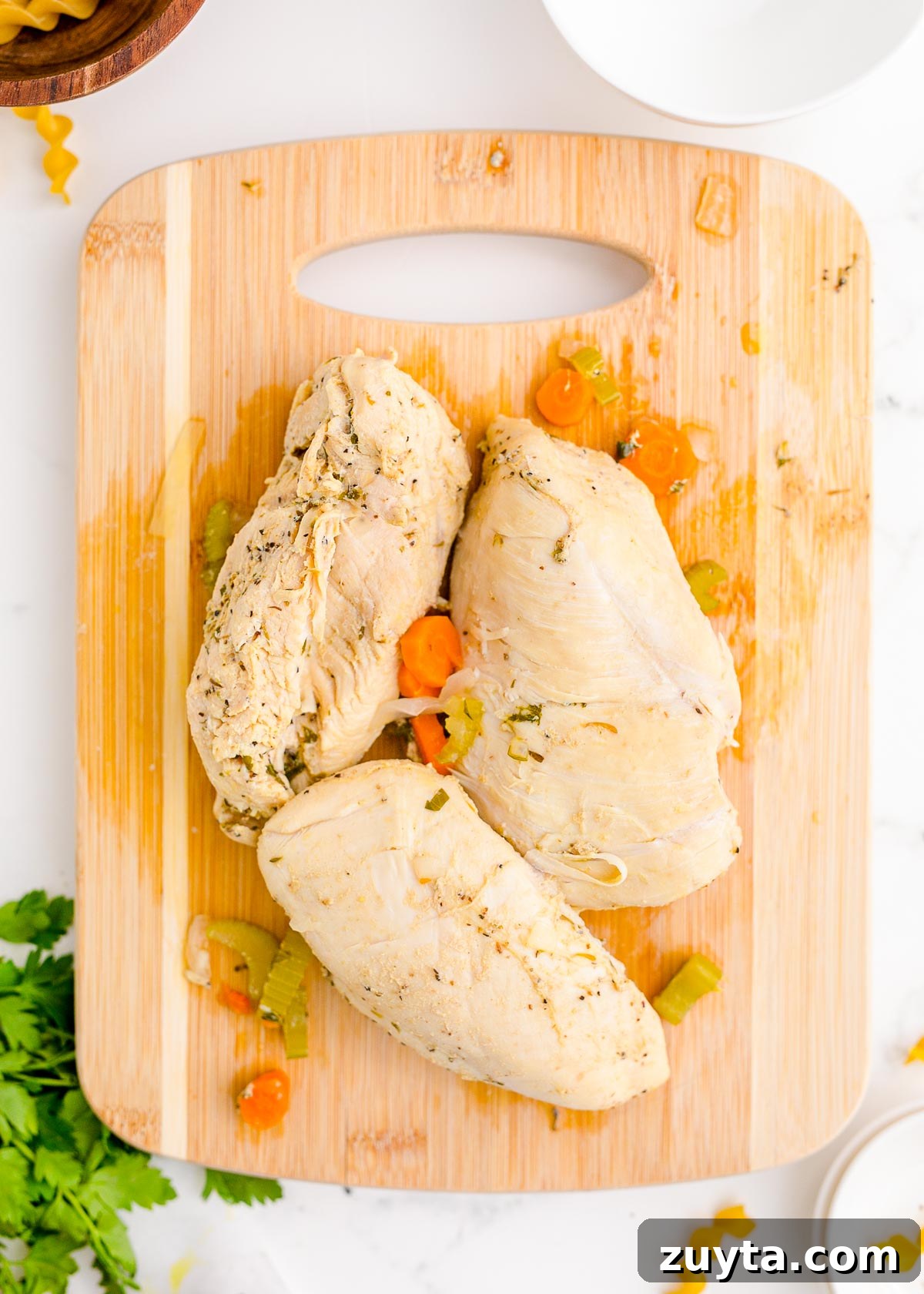 Cooked chicken on a cutting board.