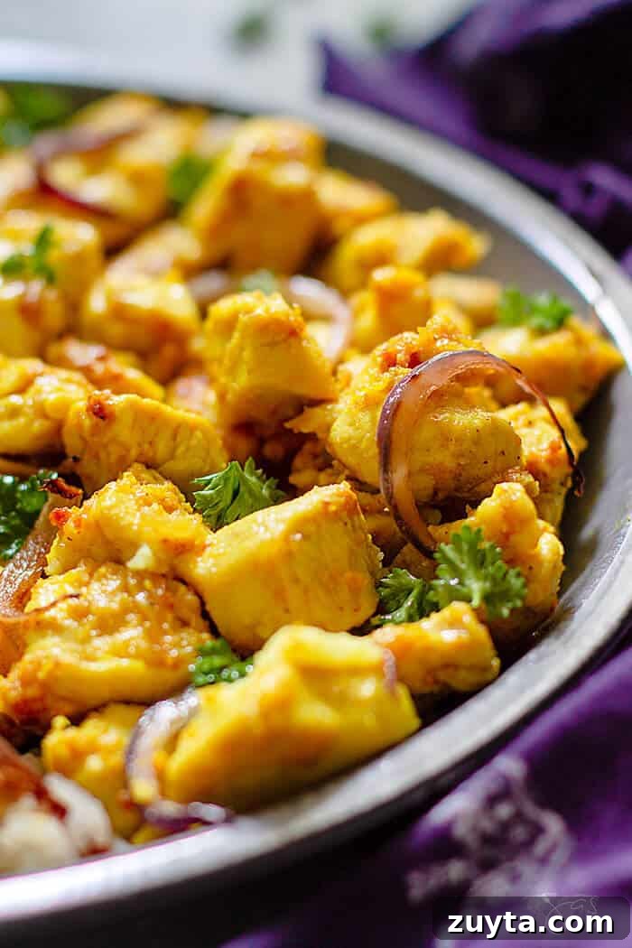 Ginger Garlic Indian Chicken Recipe 5 Angle close up shot of cooked chicken pieces with turmeric