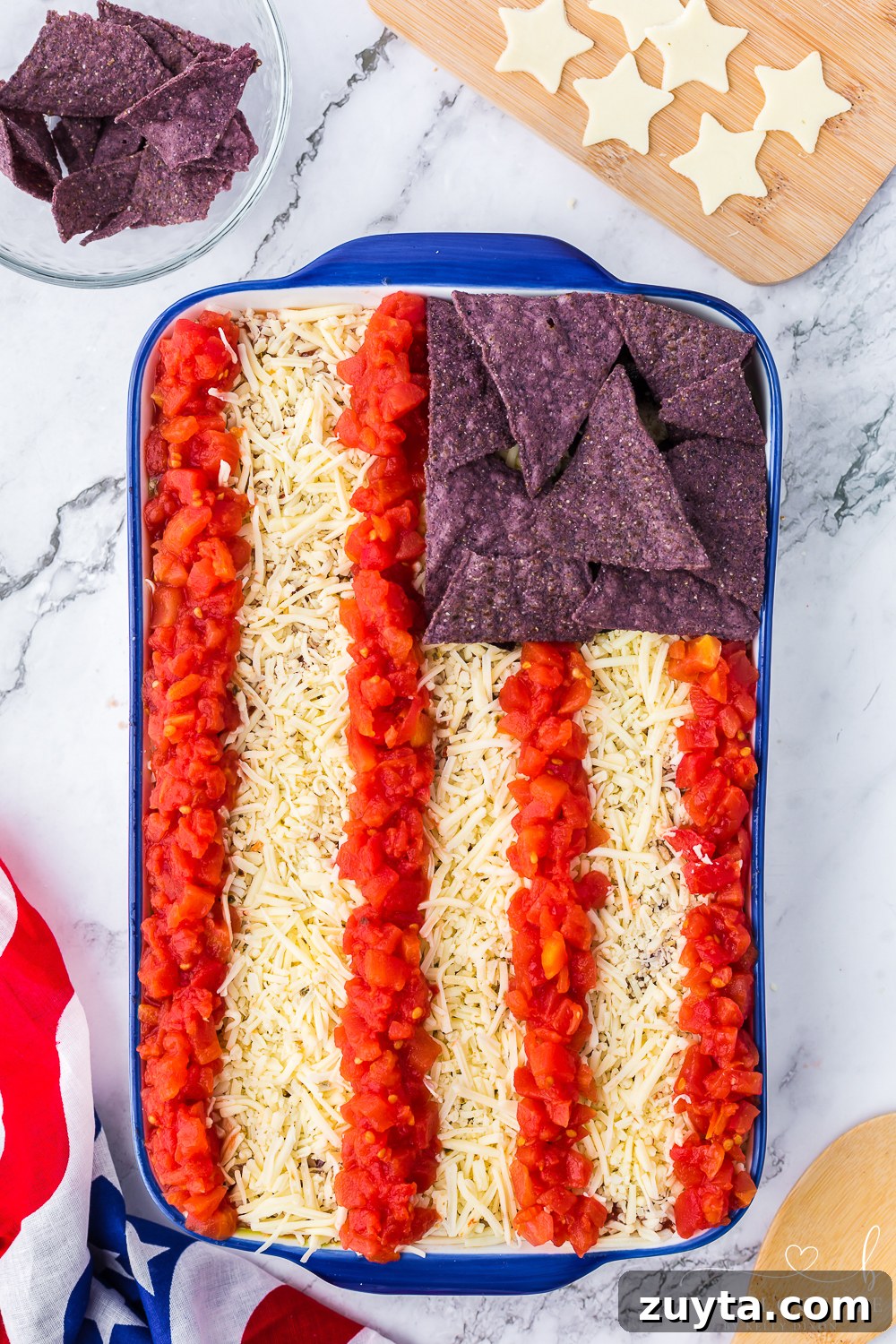 Patriotic American Flag 7 Layer Dip for Fourth of July 12 Add blue chips and red tomato stripes over the white cheese