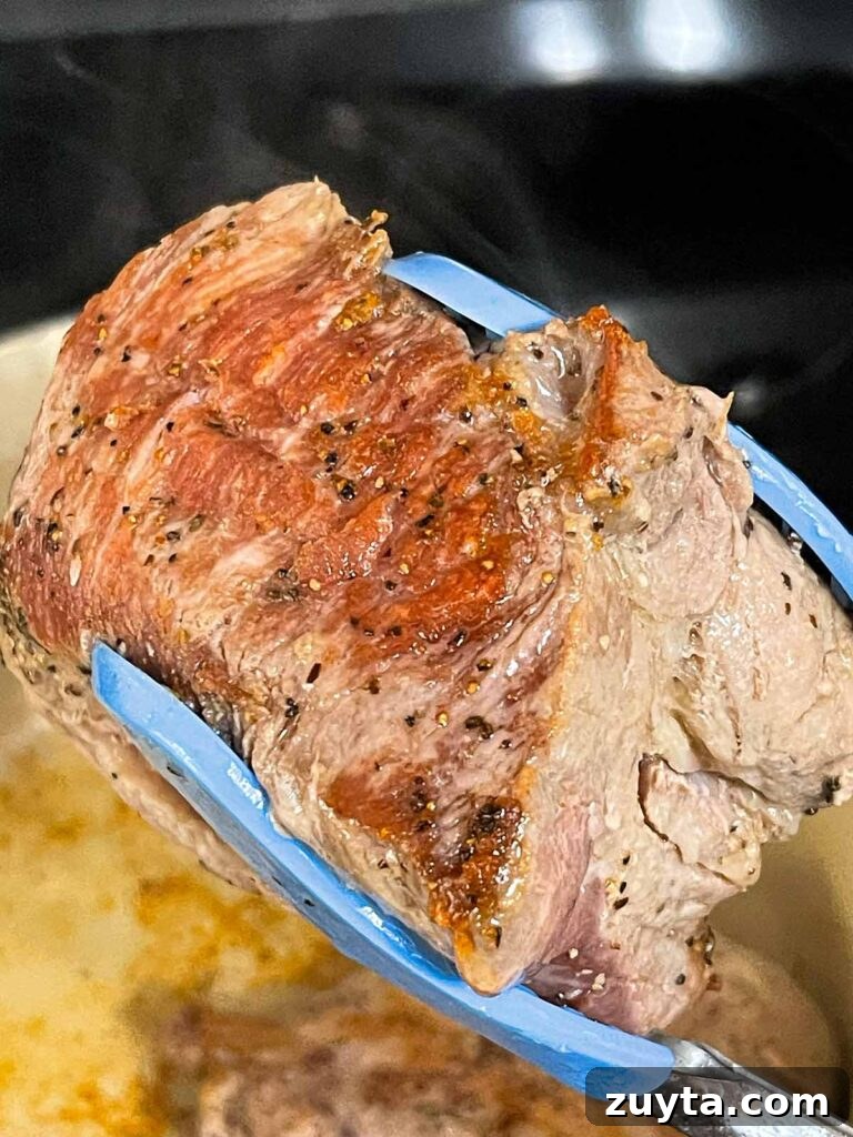 Slow-Braised Apple Cider Pork Shoulder 5 A piece of browned pork shoulder.