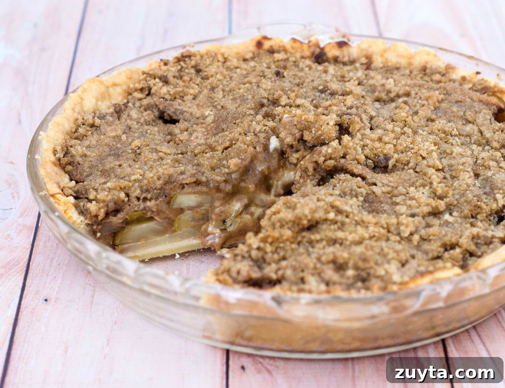Rustic Pear Pie with Hazelnut Crumble 2 Spiced pear pie with hazelnut crumb topping, served warm with a scoop of vanilla ice cream.