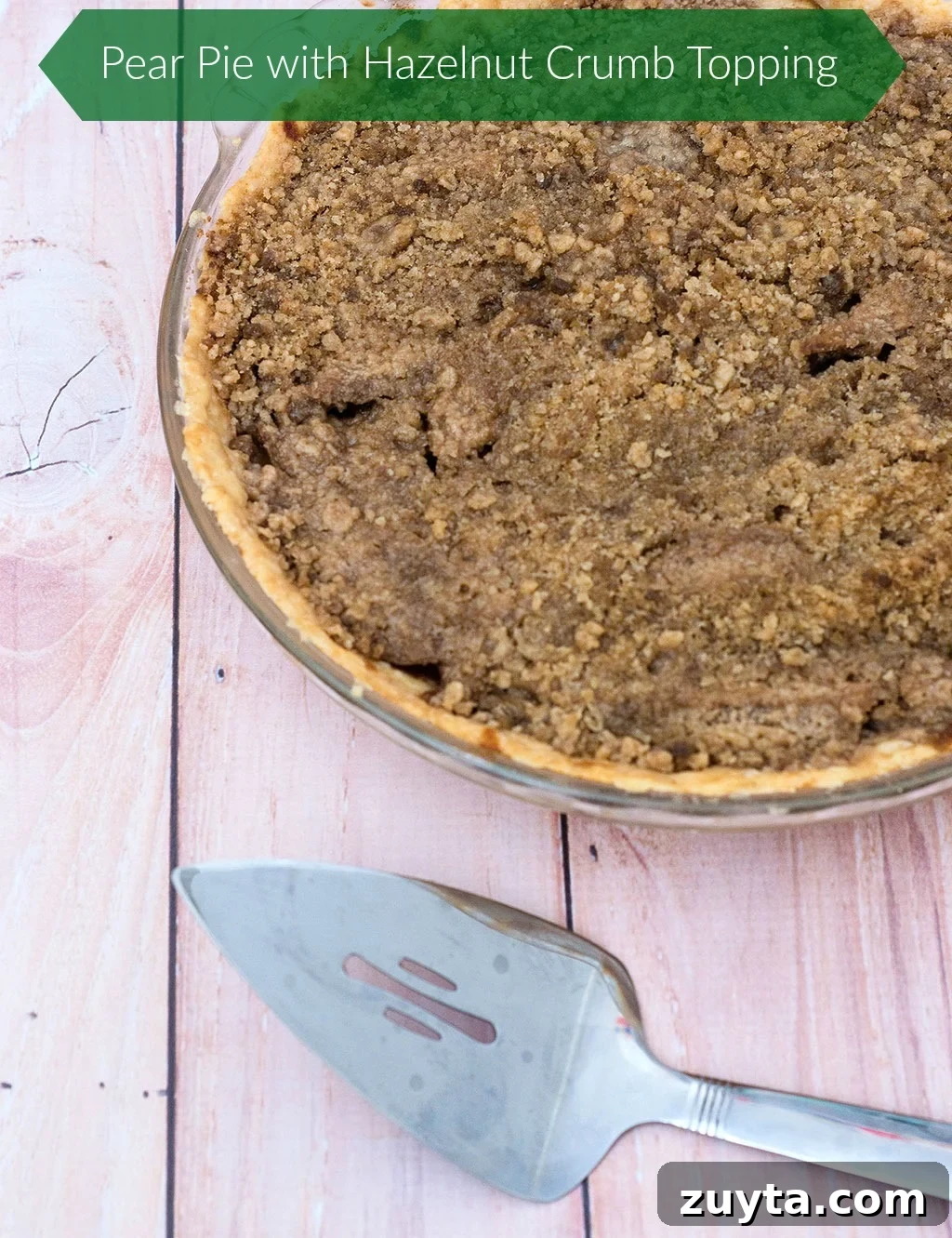 Rustic Pear Pie with Hazelnut Crumble 5 Whole pear pie with crumb topping and toasted hazelnuts.