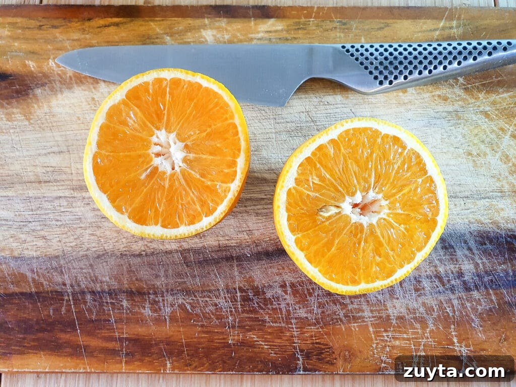 Homemade Orange Popsicles Recipe 4 Cutting oranges in half to juice.
