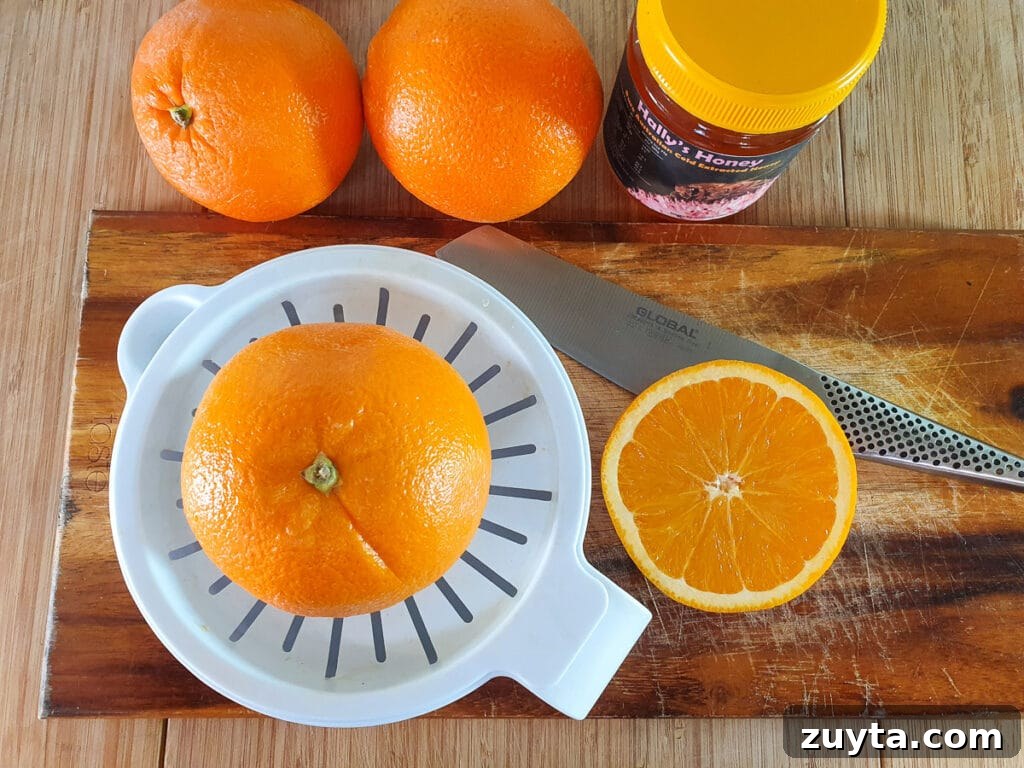 Homemade Orange Popsicles Recipe 5 Juicing oranges with a juicer.