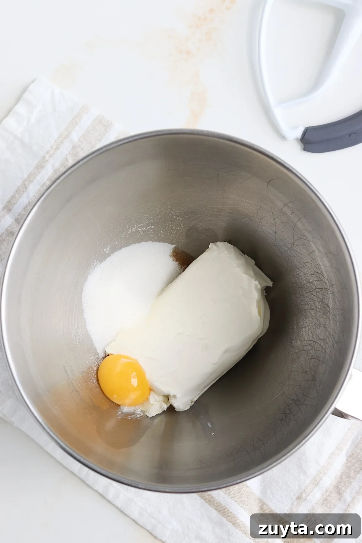 cream cheese, egg yolk and sugar in a mixing bowl