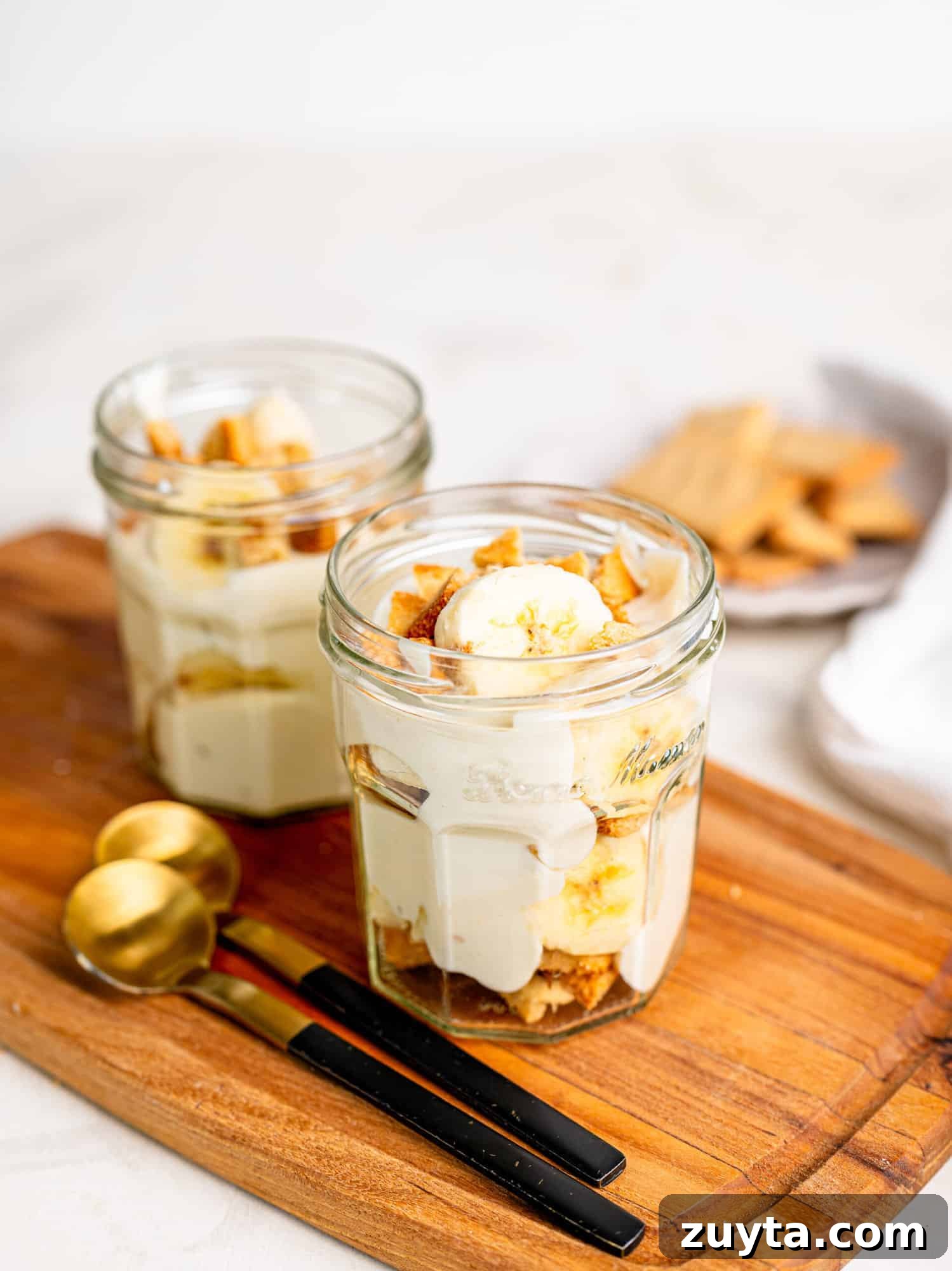 12 No-Bake Dessert Recipes for Parties and Weeknights 3 Two Healthy Banana Pudding Jars on a wooden board.