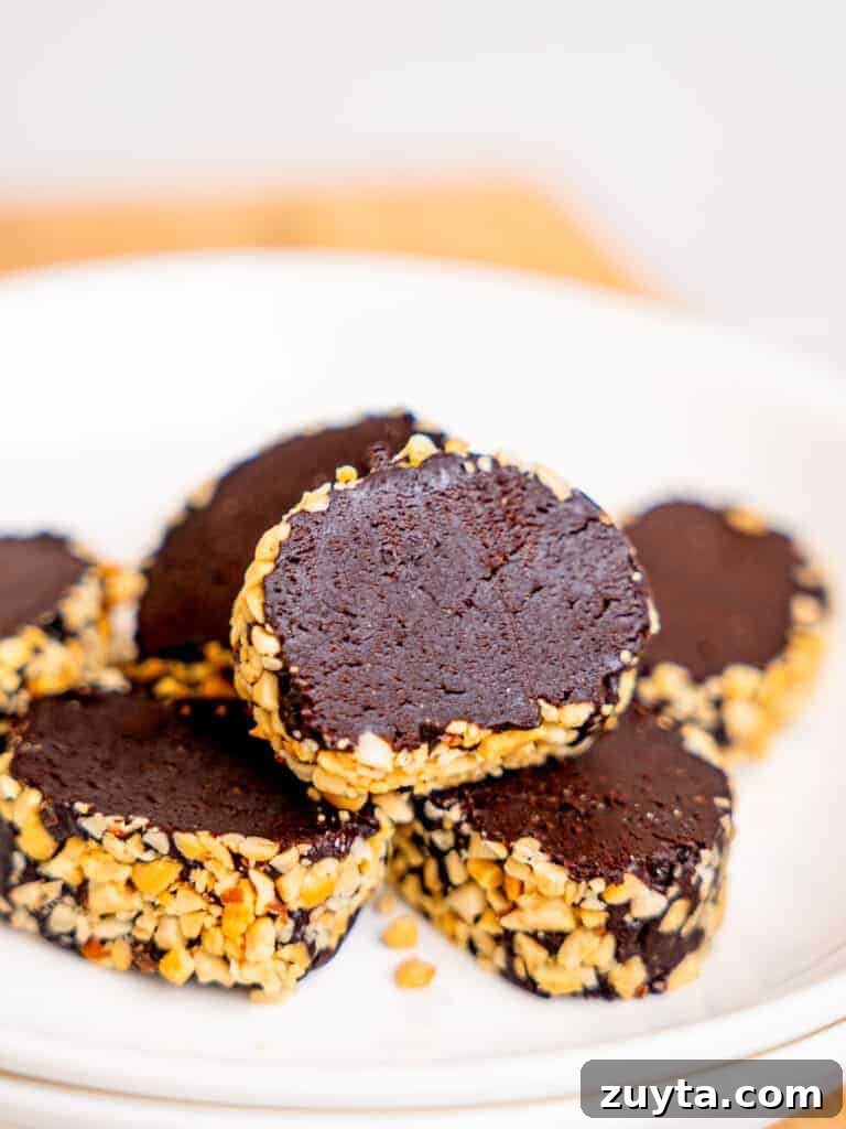 12 No-Bake Dessert Recipes for Parties and Weeknights 8 No-bake brownie batter log slices with nuts on a plate.