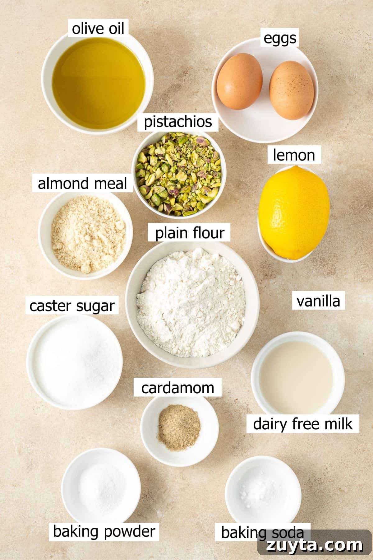 Lemon Pistachio Loaf Cake with Cardamom 3 All ingredients needed to make a lemon pistachio loaf cake laid out in small bowls.