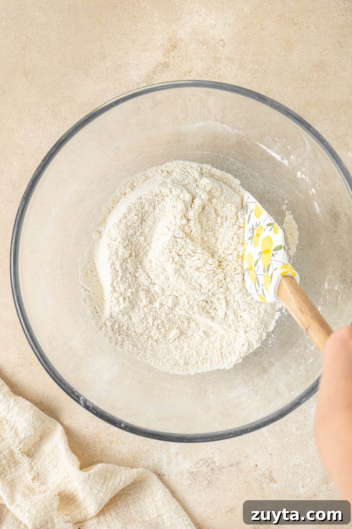 Lemon Pistachio Loaf Cake with Cardamom 5 Mixing together the dry ingredients in a glass bowl.
