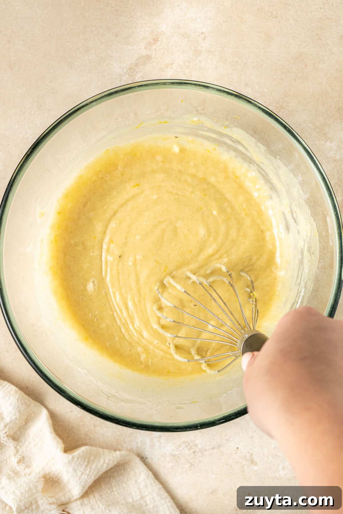 Lemon Pistachio Loaf Cake with Cardamom 6 Mixing together the cake batter in a glass bowl.