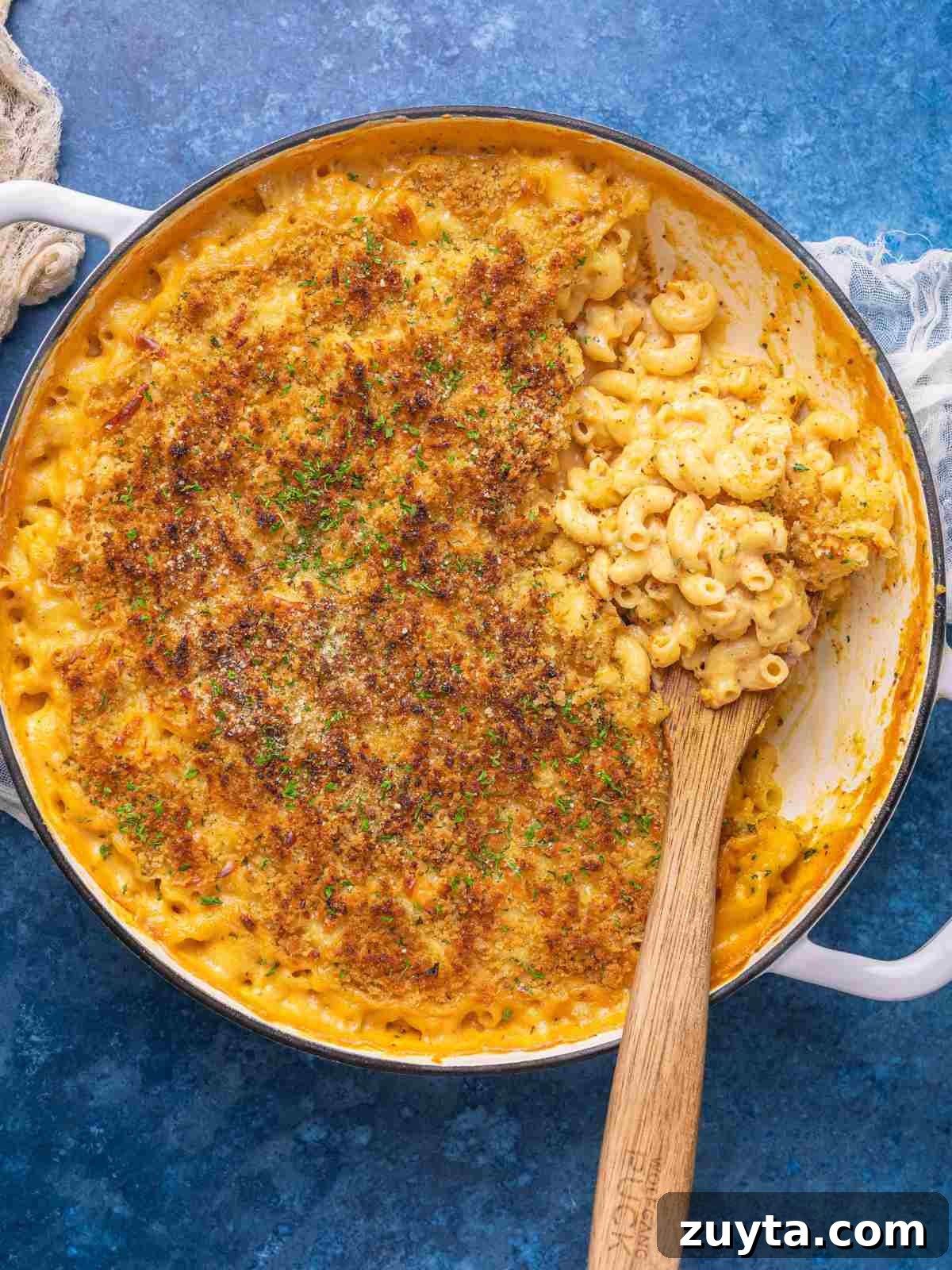 Macaroni and cheese in a casserole topped with bread crumbs, and garnished with parsley.