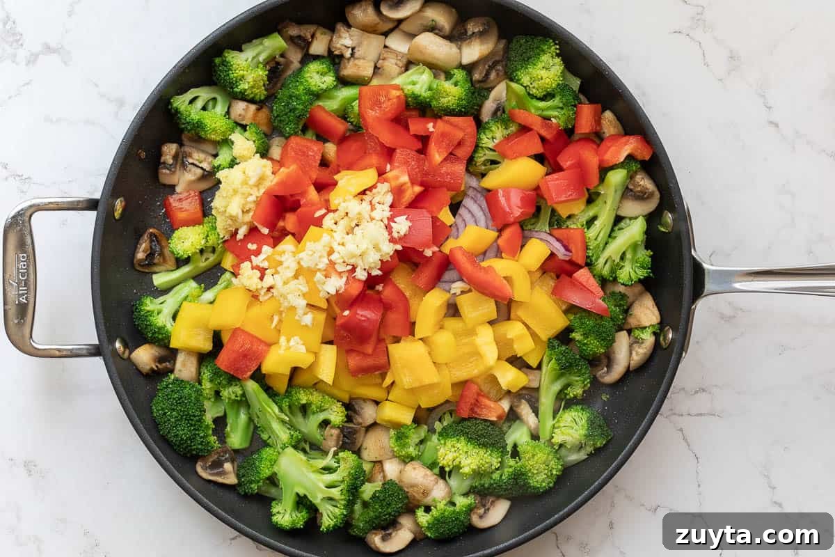 Soy-Ginger Salmon Stir-Fry with Vegetables 9 sautéed mushrooms and broccoli in pan with peppers and onions added to the middle.