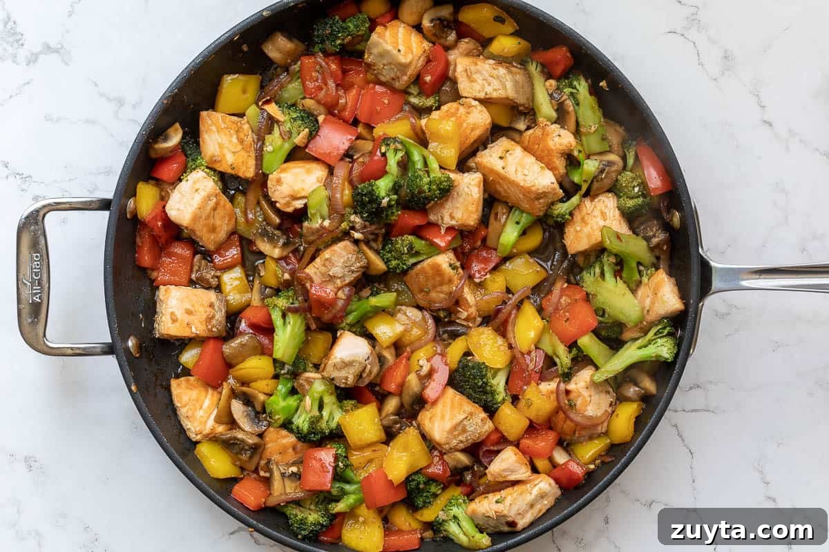 Soy-Ginger Salmon Stir-Fry with Vegetables 10 salmon stir fry with teriyaki sauce in large skillet.