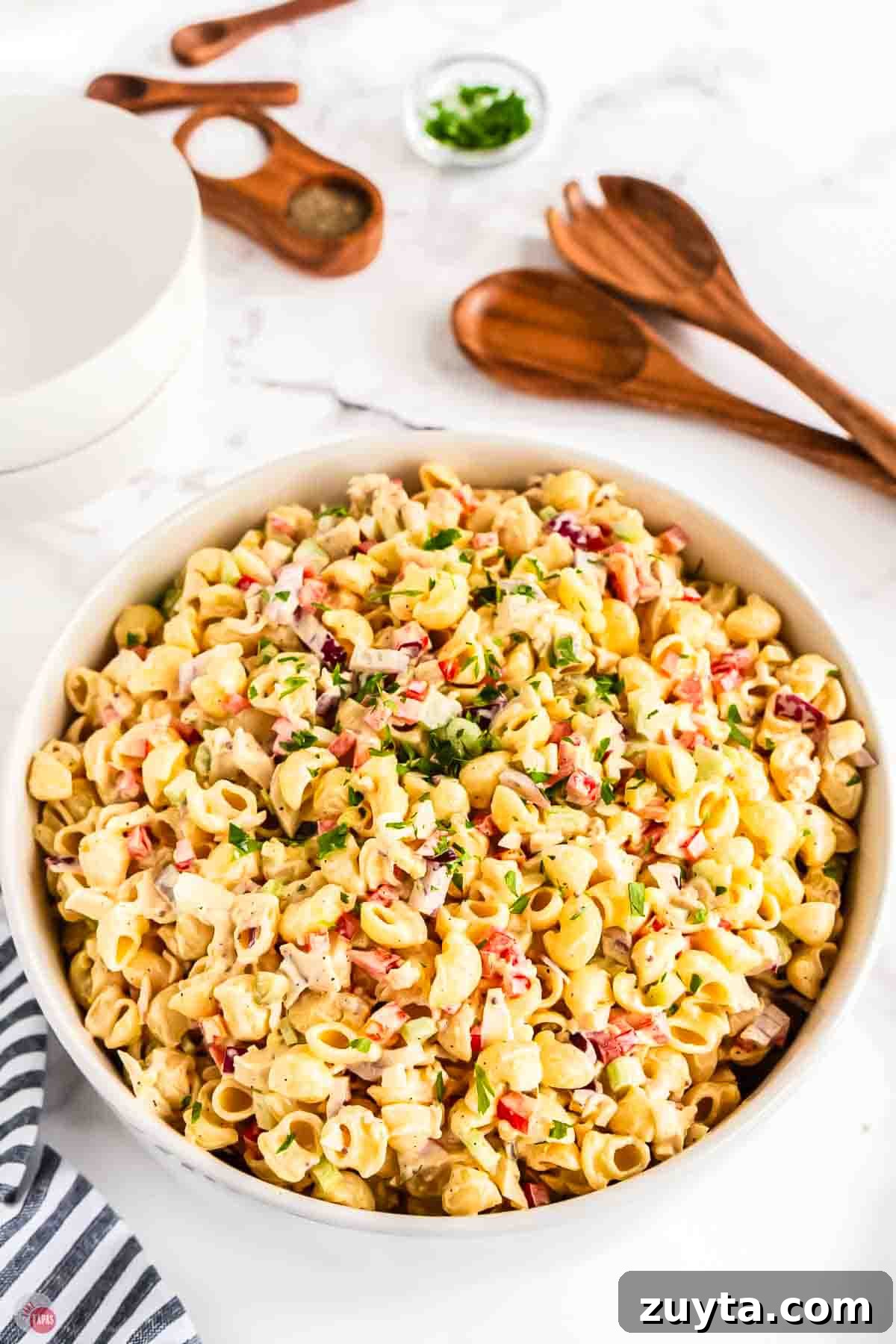 Creamy Chicken Macaroni Salad Recipe 2 large white bowl of chicken macaroni salad with wood spoons