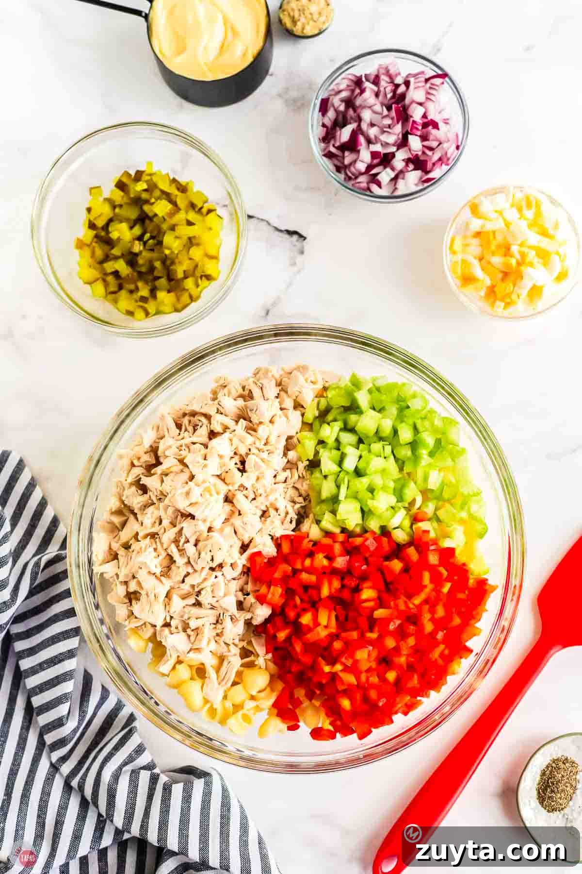 Creamy Chicken Macaroni Salad Recipe 4 large, clear mixing bowl with cooked pasta, chicken, and diced vegetables
