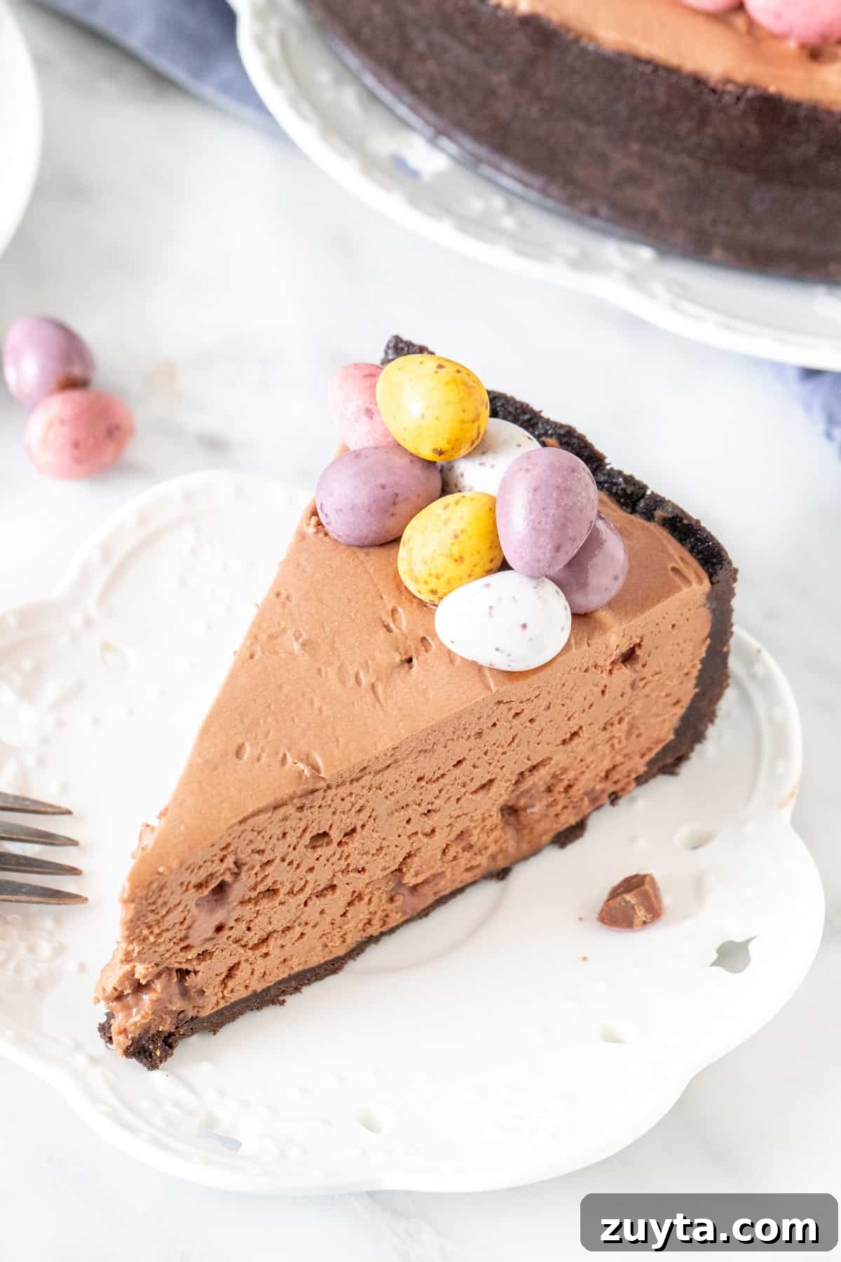 Slice of chocolate cheesecake with mini eggs on top