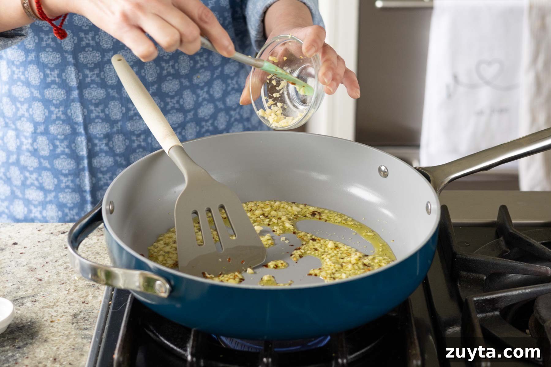 Creamy Corn Chowder with Smoky Tofu Bacon Bits 9 adding garlic and crushed pepper to the pan
