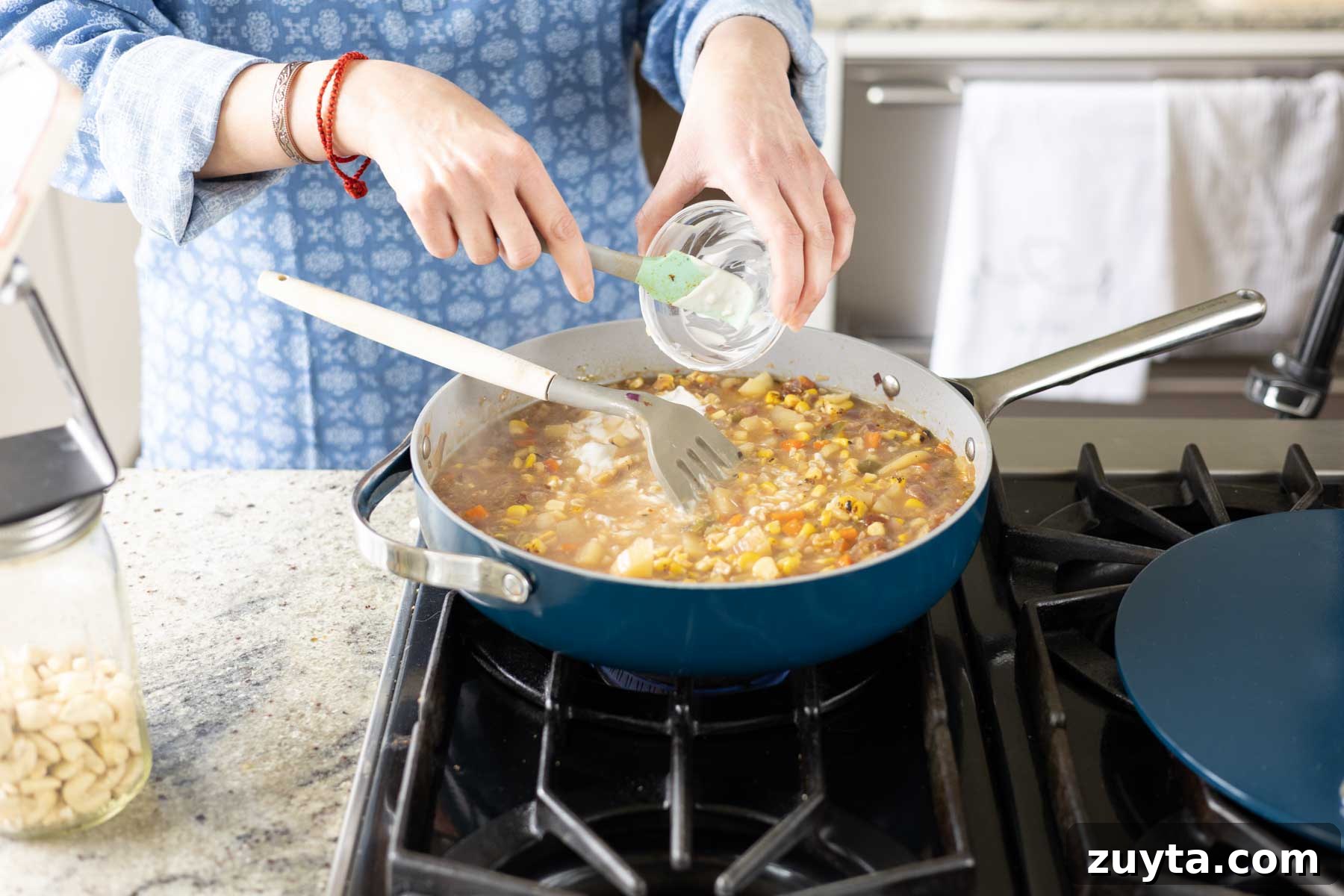 Creamy Corn Chowder with Smoky Tofu Bacon Bits 13 adding non-dairy cream to the pan
