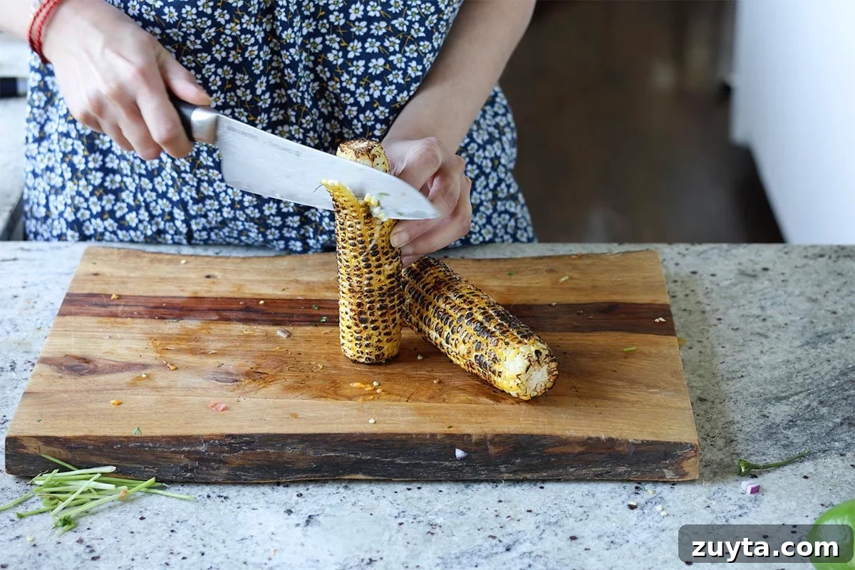 Creamy Corn Chowder with Smoky Tofu Bacon Bits 7 cutting the corn off of the cob