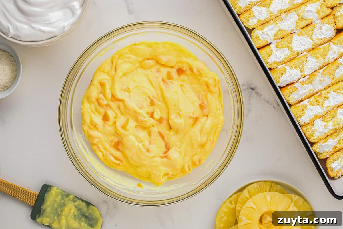 How to Make Twinkie Cake with Creamy Vanilla Filling 7 pudding with mango chunks in a glass bowl.