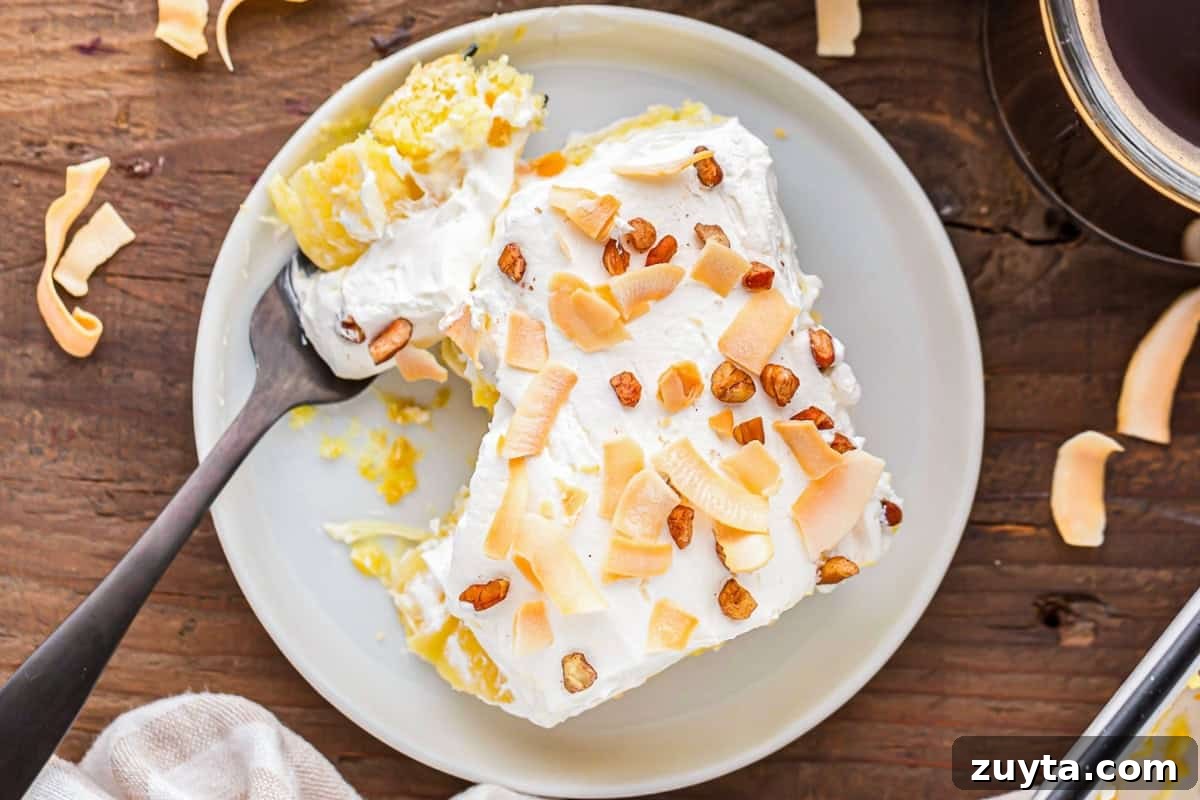 How to Make Twinkie Cake with Creamy Vanilla Filling 2 overhead view of a slice of partially eaten twinkie cake on a plate with a fork.