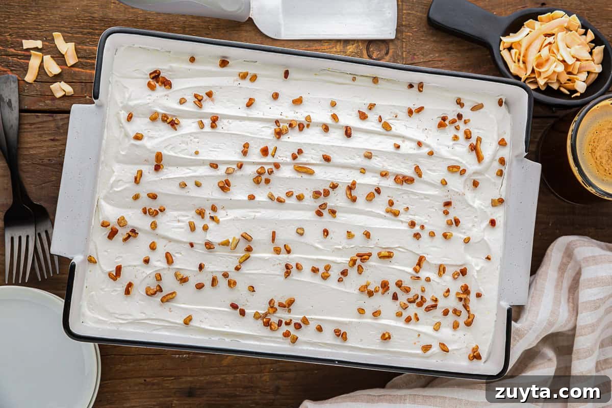 How to Make Twinkie Cake with Creamy Vanilla Filling 8 twinkie cake topped with whipped topping and coconut flakes.