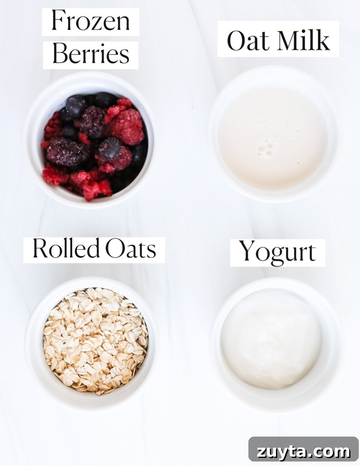Creamy Overnight Oats with Frozen Fruit 3 Small white bowls filled with ingredients that are labeled including: frozen berries, oat milk, rolled oats, yogurt,