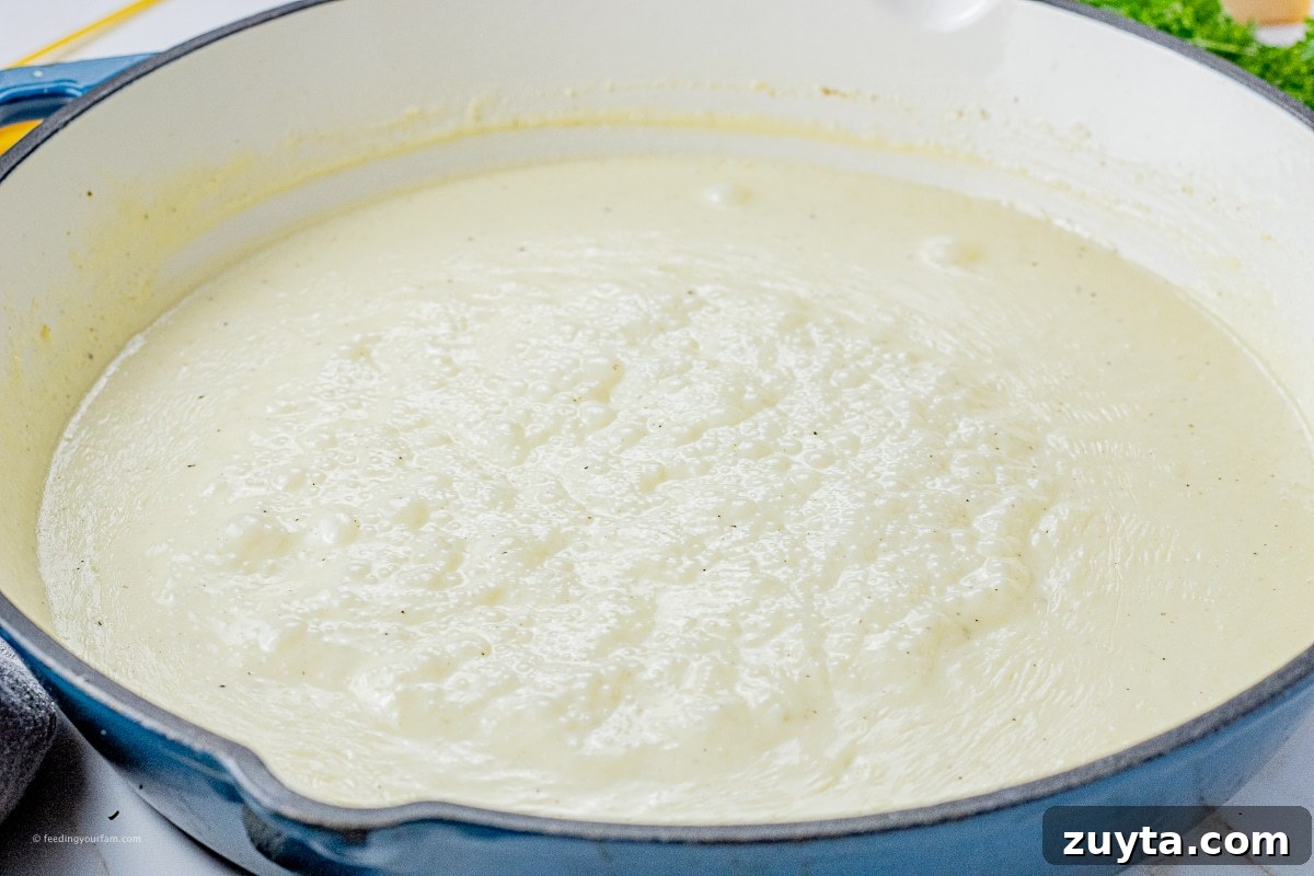 5-Ingredient Creamy Homemade Alfredo Sauce 5 simmering alfredo sauce in a large skillet
