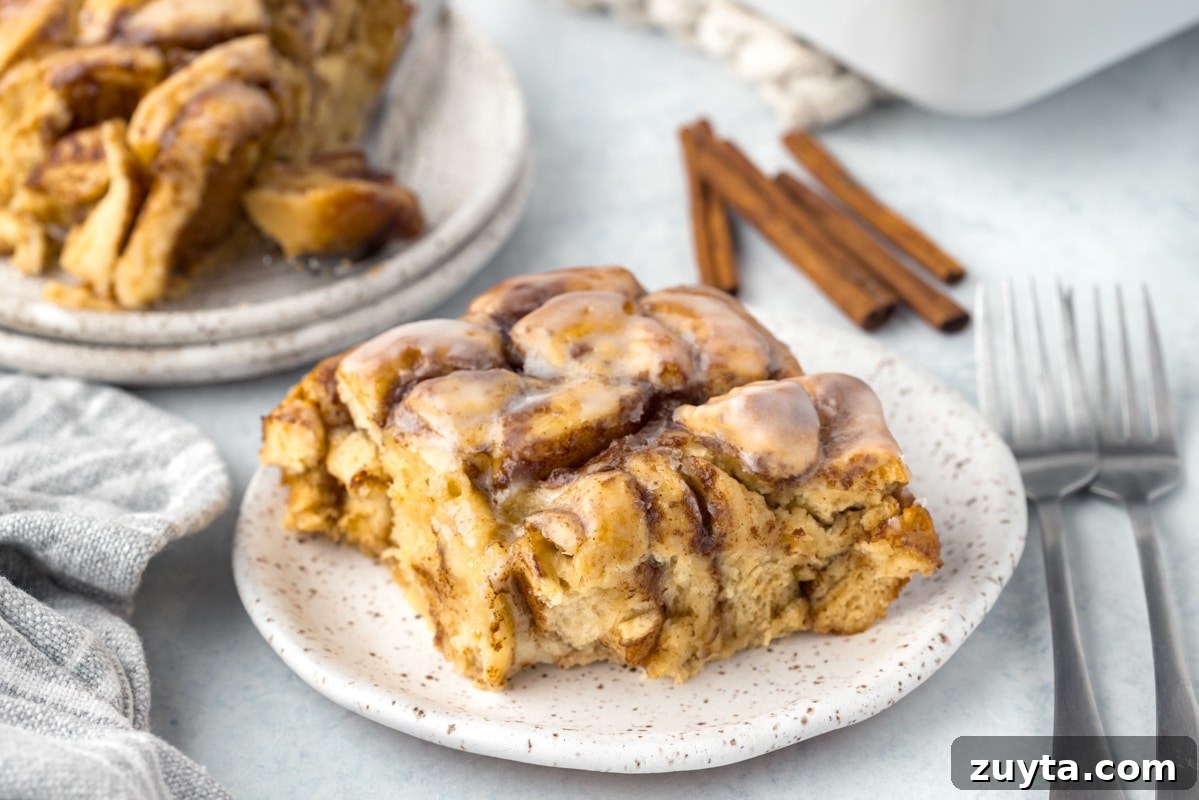 Cinnamon Roll Casserole Recipe with Cream Cheese Glaze 13 Cinnamon roll bake on a plate.