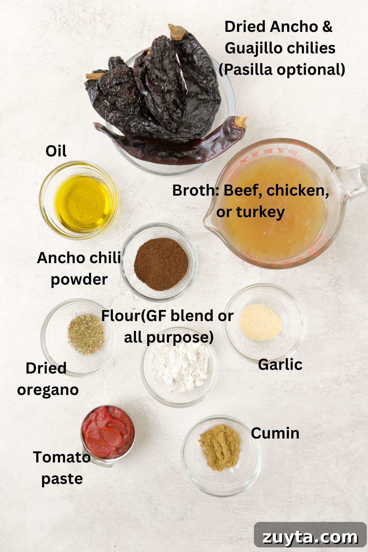 Ingredients in prep bowls to make red enchilada sauce with dried chilies, spices, oil, and broth.