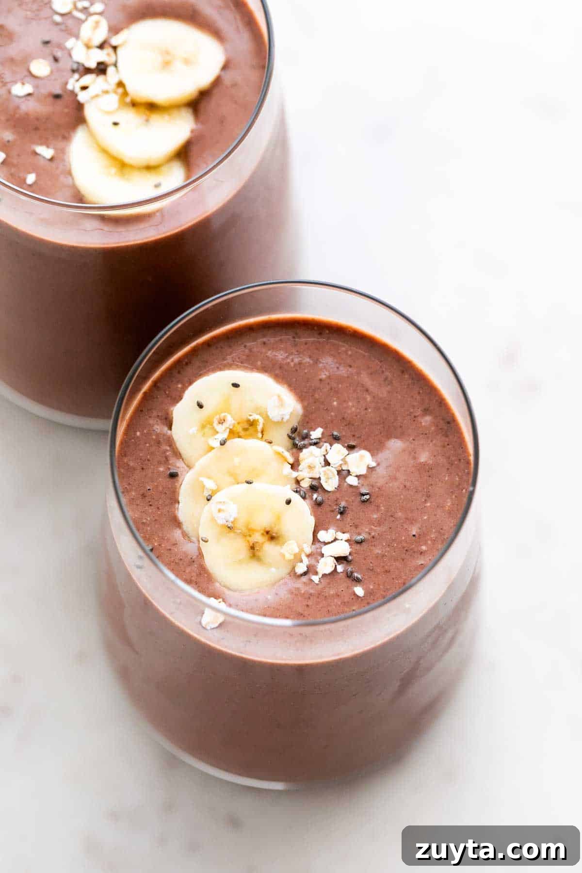 Creamy Vegan Protein Shake Recipe 2 Two glasses brimming with vegan protein shake.