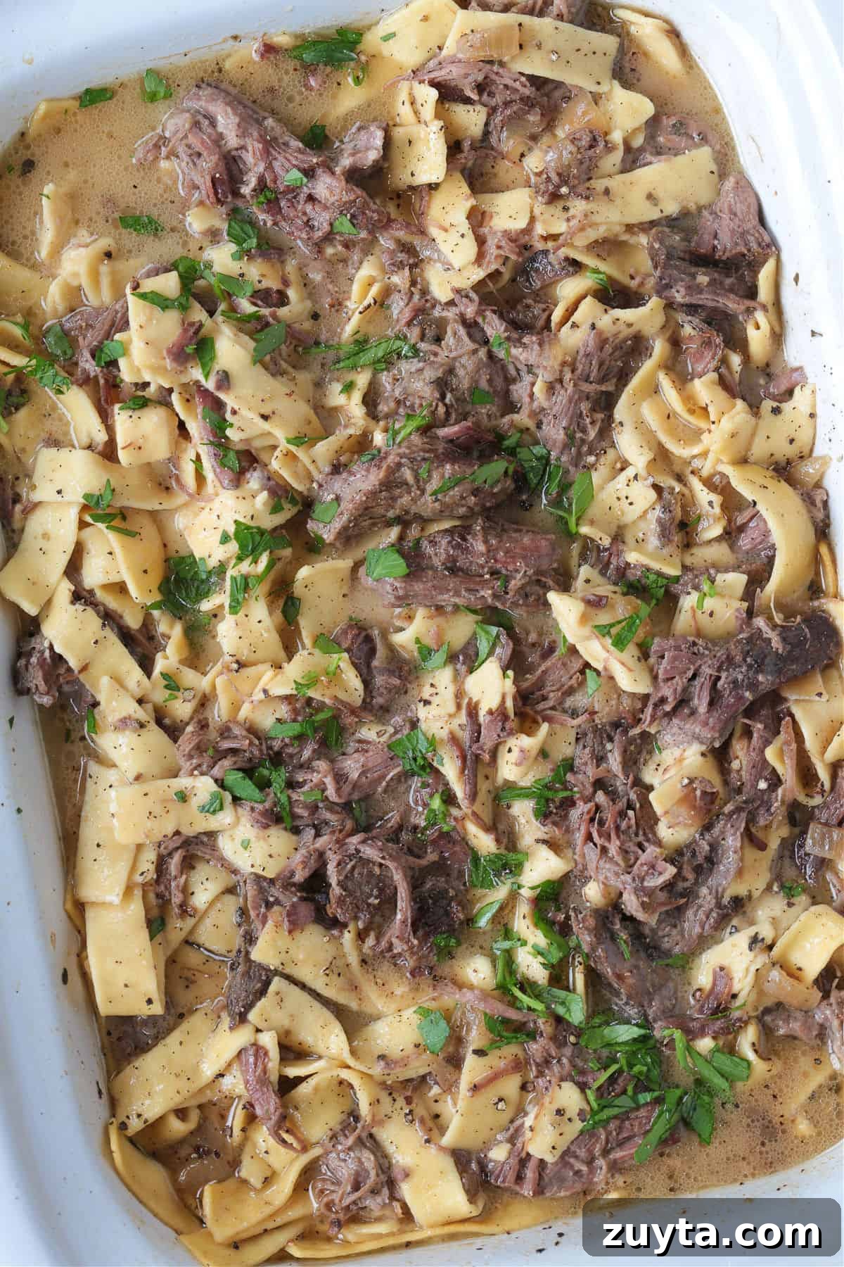 slow cooker with shredded beef and noodles
