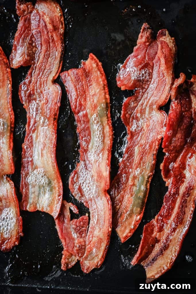 Roasted bacon sizzling in a pan