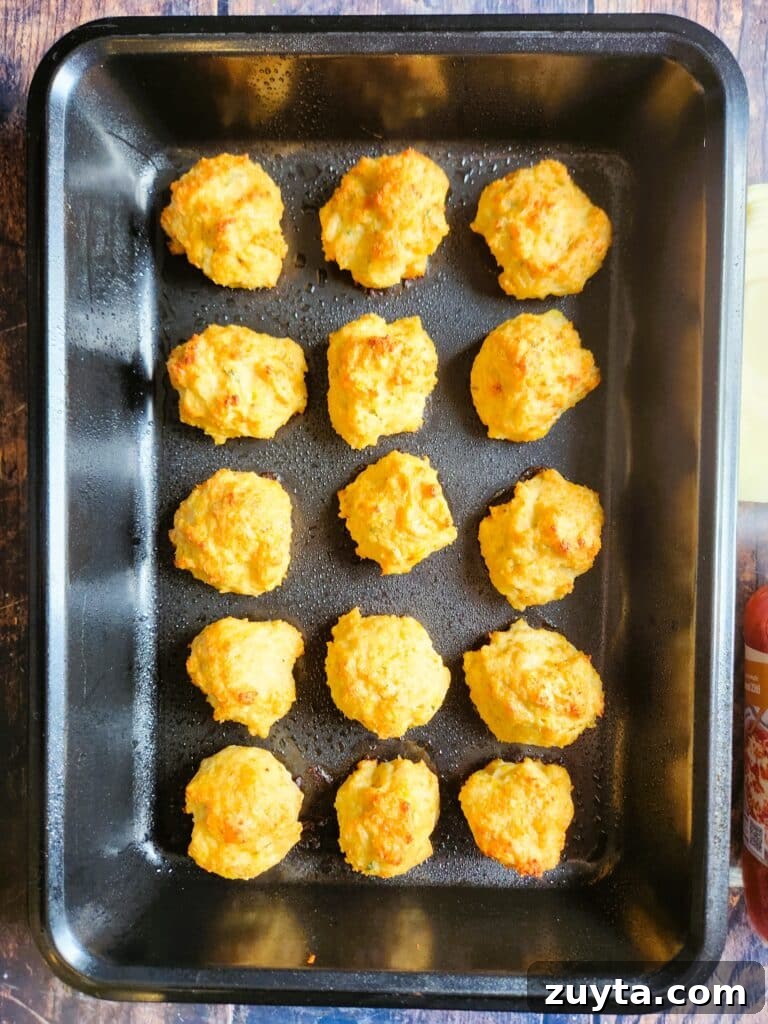 Baked Chicken Meatballs with Mozzarella in Tomato Sauce 6 Golden baked chicken meatballs fresh from the oven on a baking tray