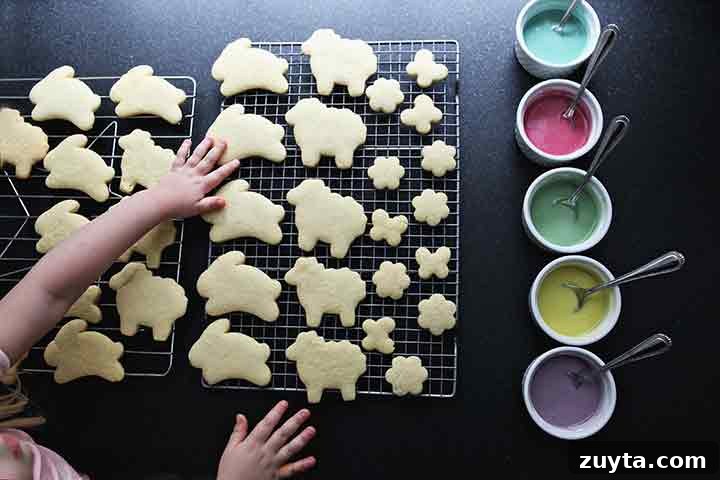 Lemon Tea Cakes Recipe with Zesty Glaze 4 A girl touches lemon sugar cookies as they cool on wire racks