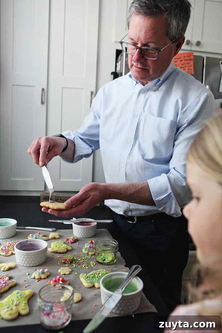 Lemon Tea Cakes Recipe with Zesty Glaze 6 A man and a girl decorate Soft Lemon Tea Cakes in a kitchen