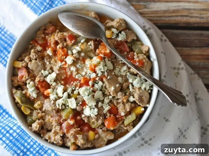 bowl of buffalo chili surround by napkins with a spoon in the bowl