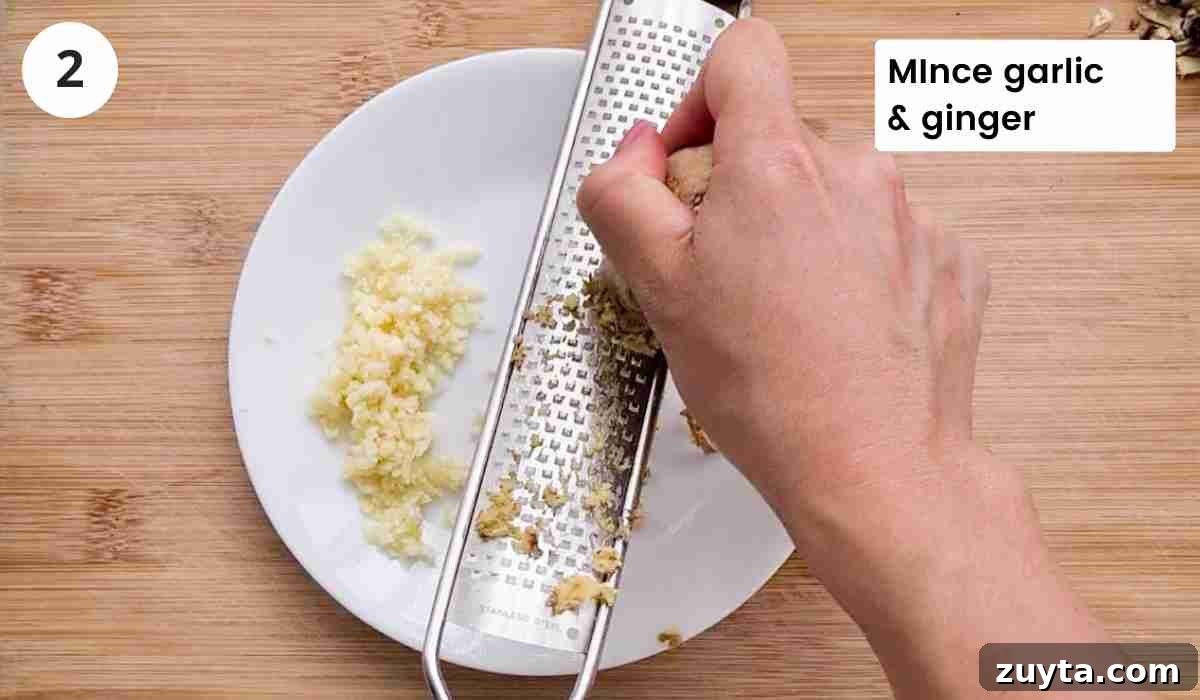 How to Make Authentic Chinese Chicken Dumplings 5 ginger being grated using a zester with captions
