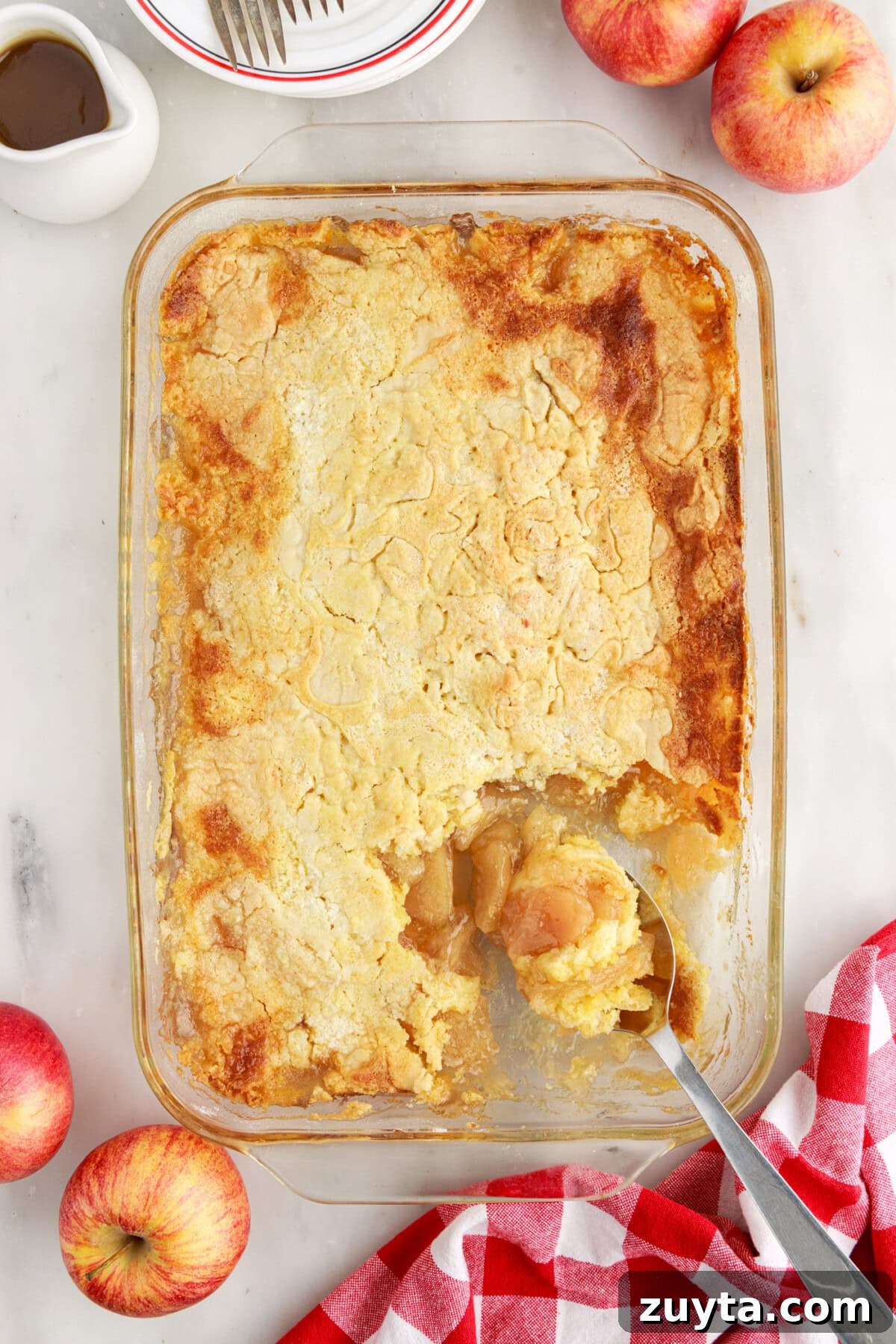 Classic Apple Dump Cake Recipe with Cinnamon 9 Pan of Apple Dump Cake with a spoon in it