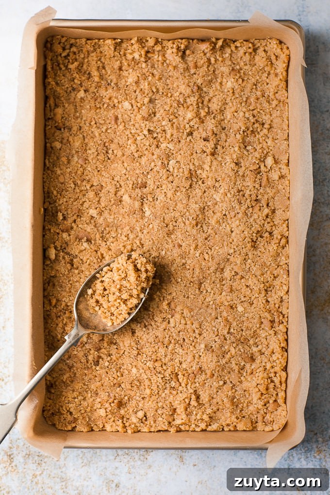 Creamy White Chocolate Raspberry Cheesecake Bars Recipe 4 Cheesecake base pressed into a baking pan.