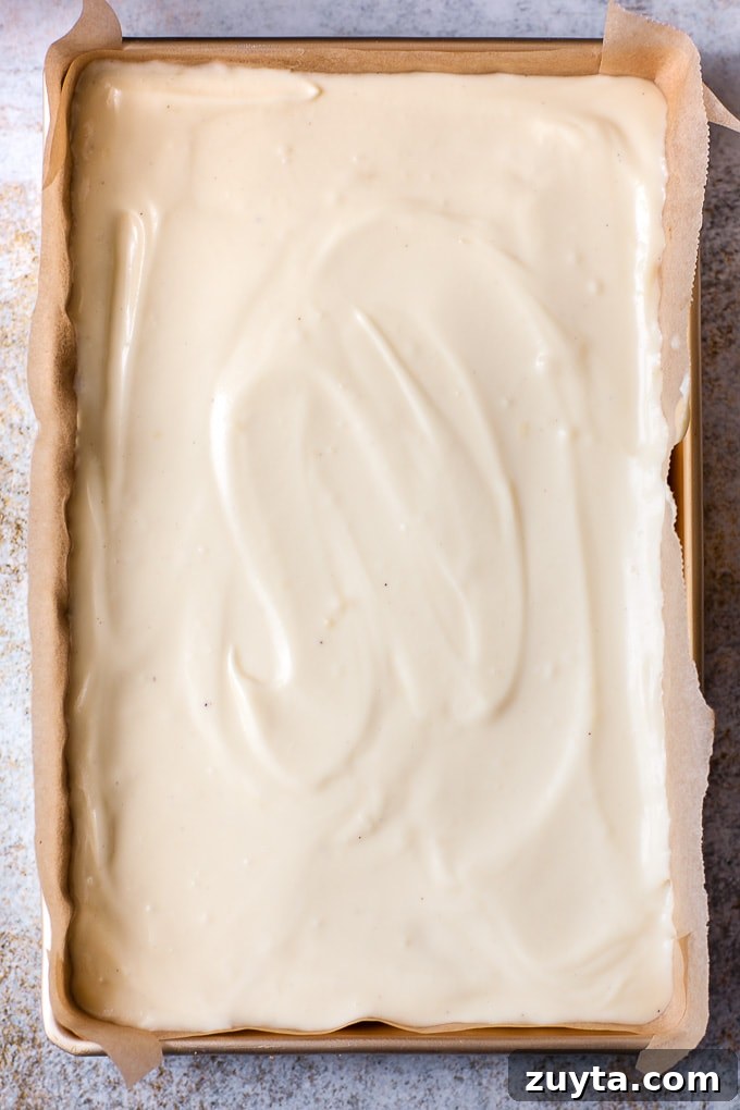 Creamy White Chocolate Raspberry Cheesecake Bars Recipe 5 Cheesecake filling in a pan for making bars.