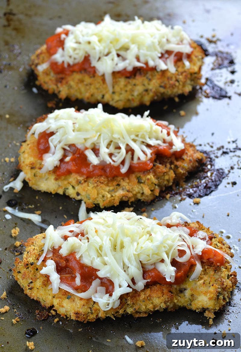 Crispy Baked Chicken Parmesan Recipe with Marinara 6 Three pieces of Baked Chicken Parmesan with marinara sauce on top, then sprinkle with shredded cheese
