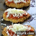 Three pieces of baked chicken parmesan