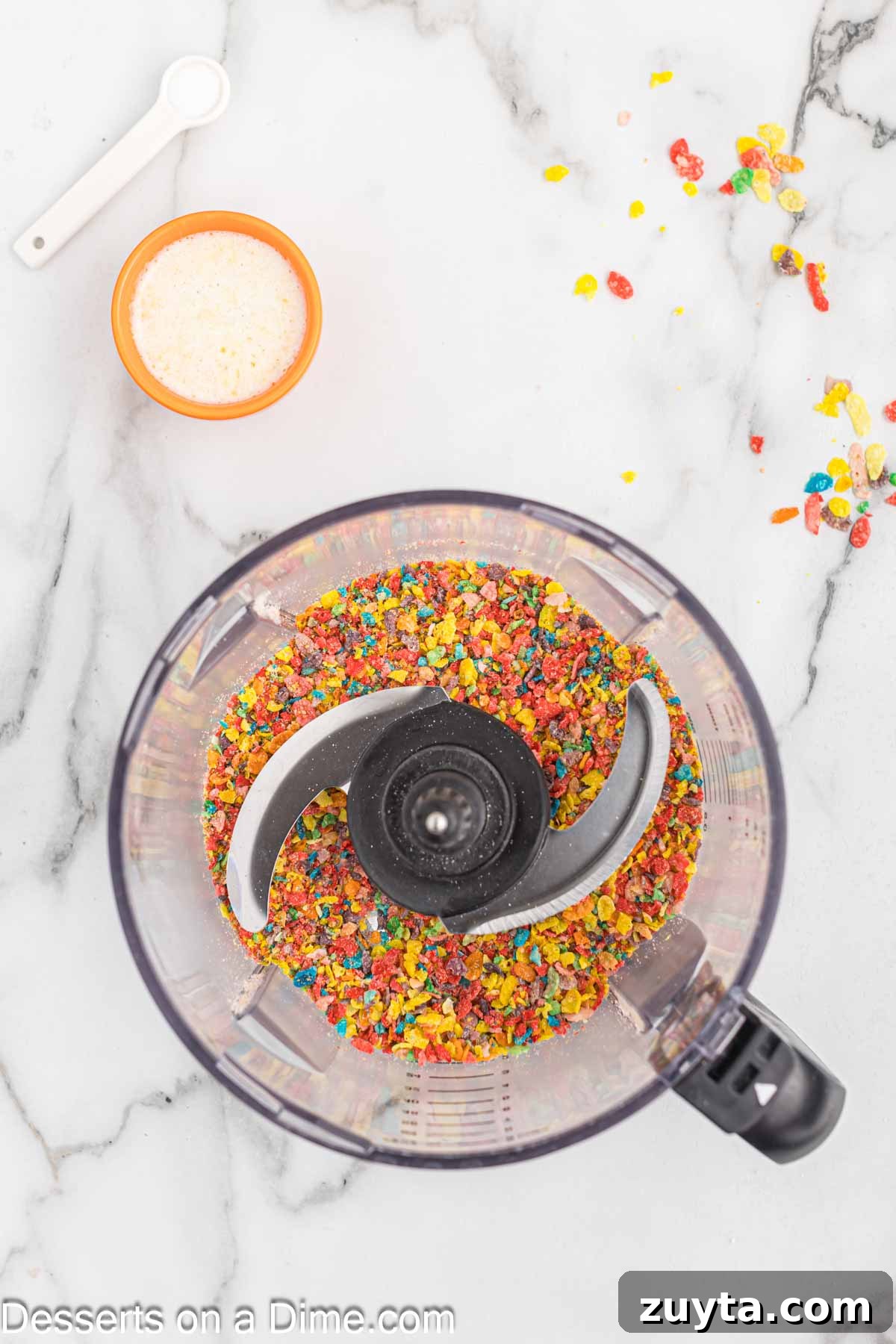 Fruity Pebbles Cheesecake Recipe with Rainbow Cereal Topping 4 Cereal in food processor.