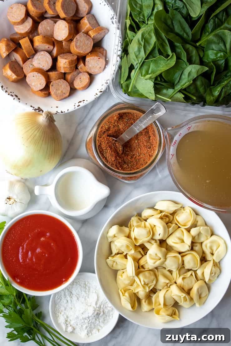 Creamy Cajun Tortellini Soup Recipe 3 Ingredients displayed on marble board.