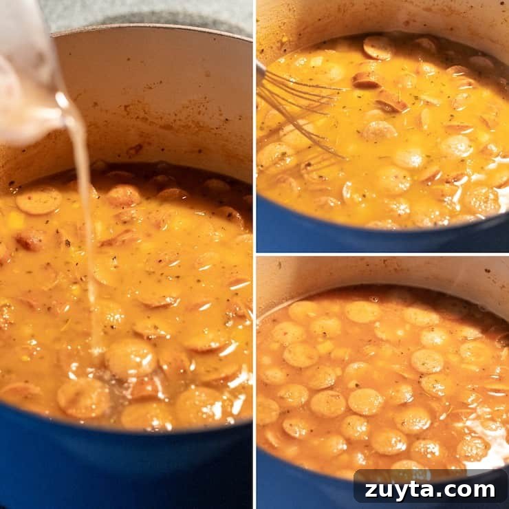 Creamy Cajun Tortellini Soup Recipe 6 Adding chicken stock and tomato sauce, simmering in pot.